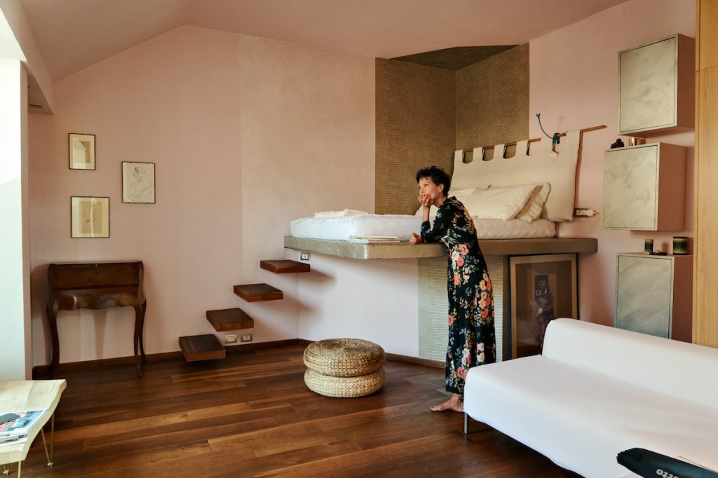 An Airbnb host in a living room standing.