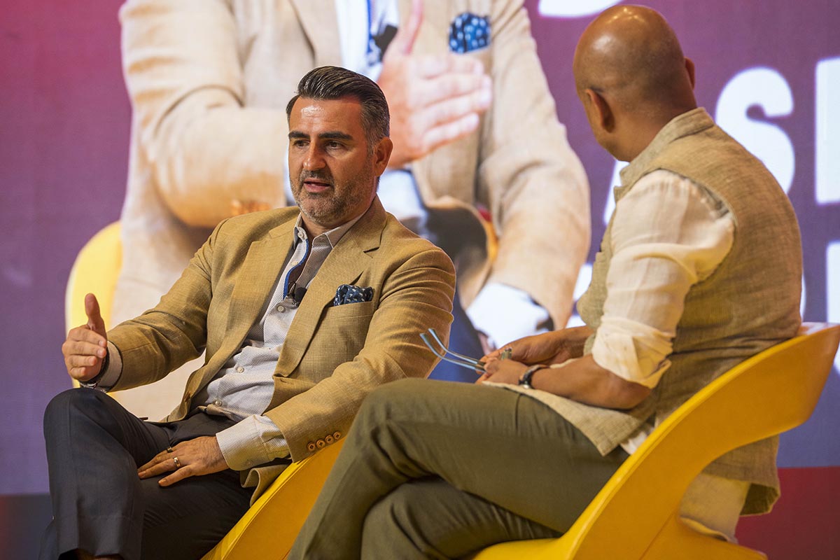two men seated on a stage