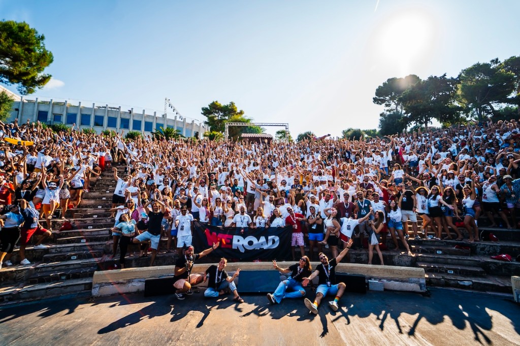 A crowd of people sitting outside celebrating